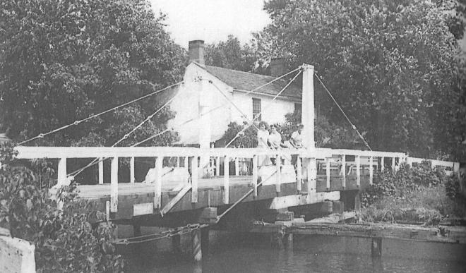 Three women on a bridge at Griggstown. Tender's house in the background. Is this where Frances Stults lived and worked? (Image from 